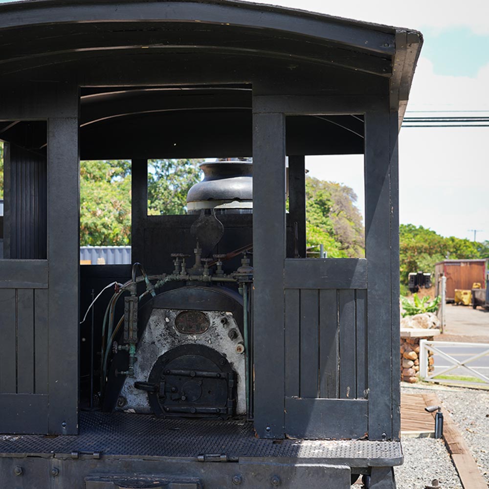 image of historic smokestack and trains in Lahaina.